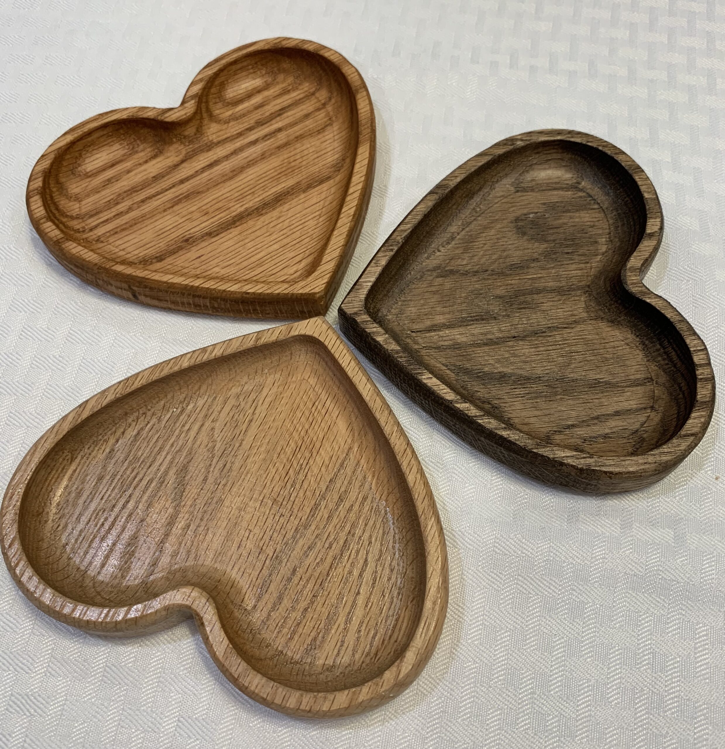 three wooden heart trinket bowls stained in pecan, walnut and natural color